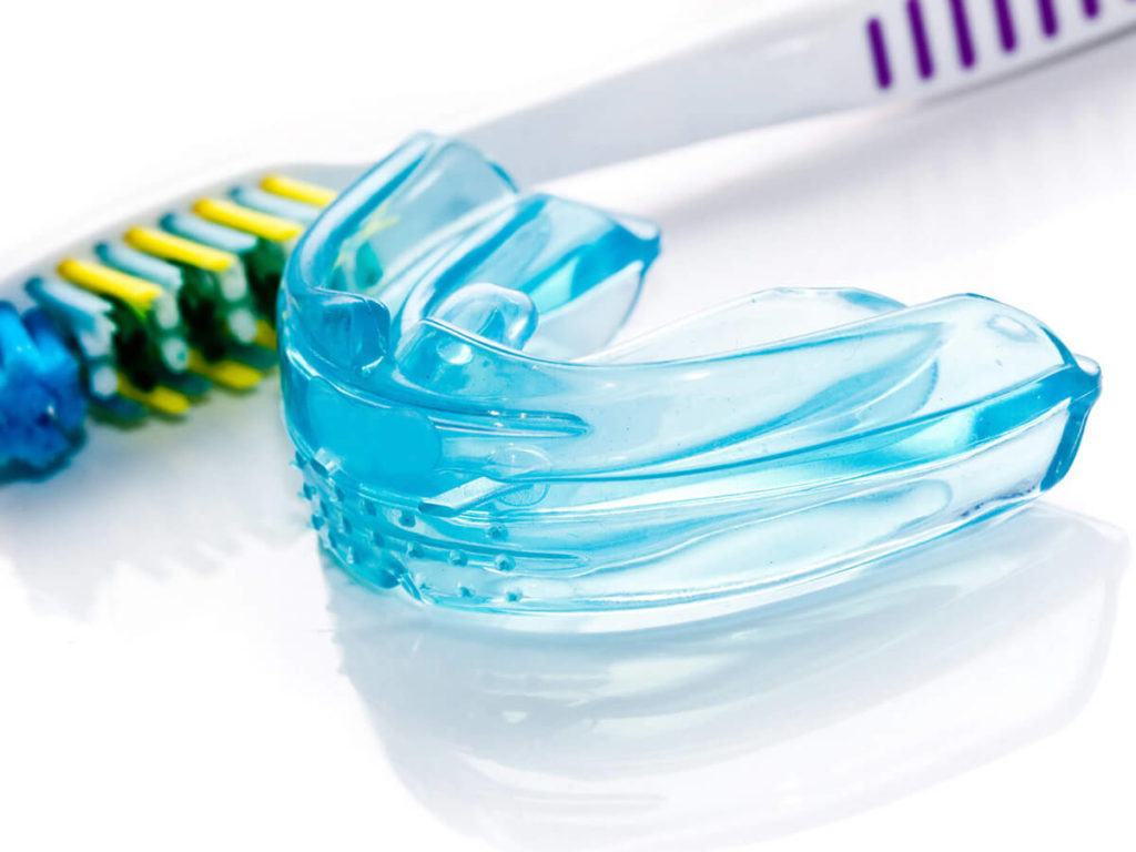 mouthguard with a toothbrush on a white background