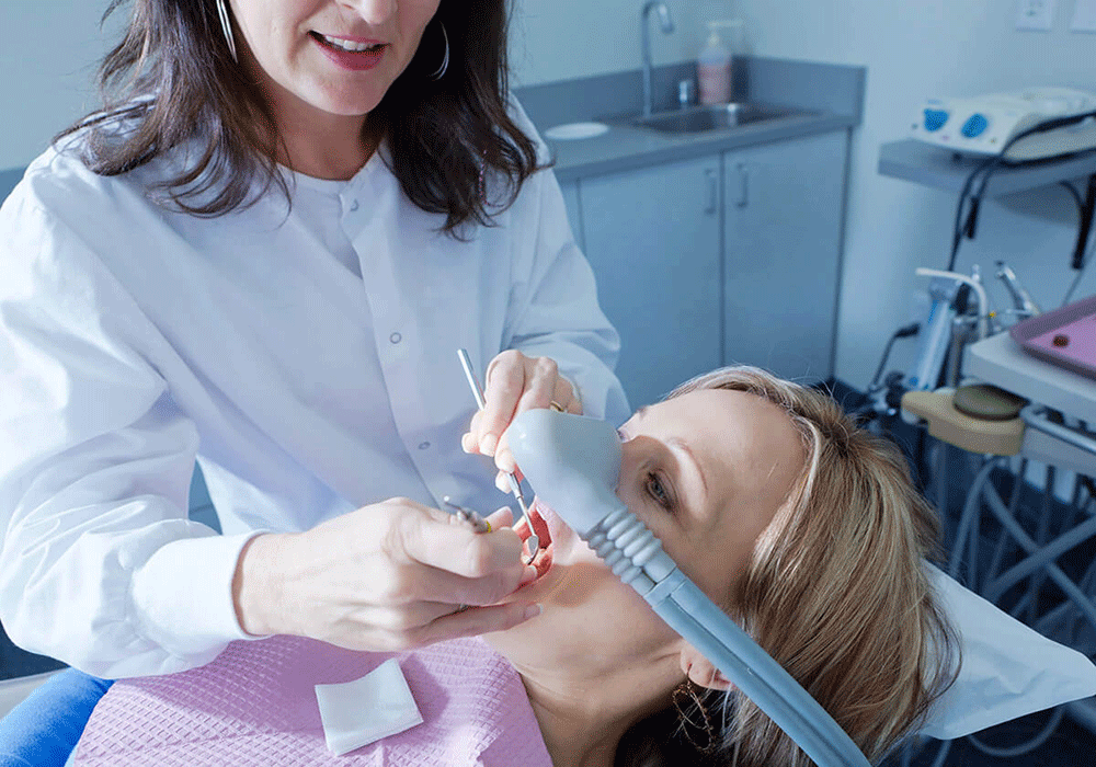 patient being sedated while having her teeth worked on