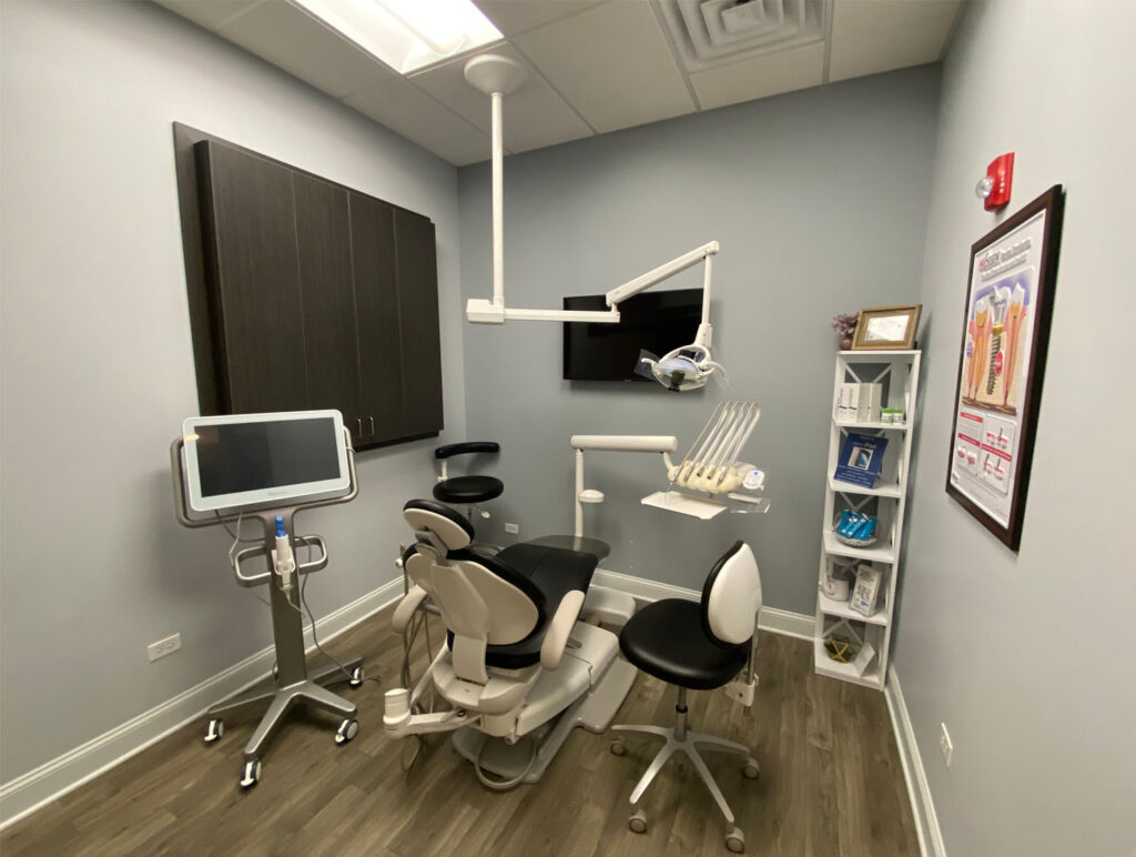 patient room with an operating chair, dental tools, and a intraoral scanner